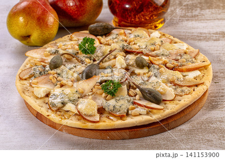 Gourmet pear blue cheese flatbread pizza with pine nuts and capers 141153900