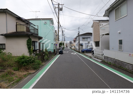 Japanese Residential Street with Modern Family Houses in Quiet Neighborhood Japanese Residential Street with Modern Family Houses in Quiet Neighborhood 141154736