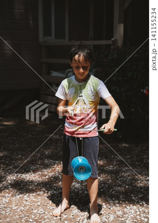 Boy Playing Diabolo Outdoors 141155234