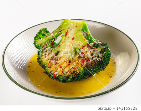 Roasted broccoli with cheese and chili flakes in ceramic bowl Roasted broccoli with cheese and chili flakes in ceramic bowl 141155528