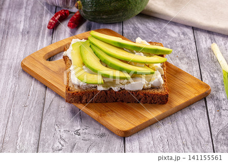 Avocado toast with cream cheese on wooden board Avocado toast with cream cheese on wooden board 141155561