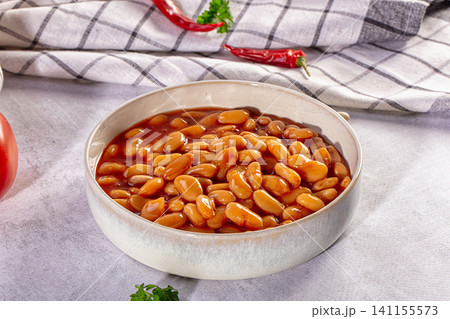 Baked beans in a ceramic bowl with tomato sauce and chili peppers Baked beans in a ceramic bowl with tomato sauce and chili peppers 141155573