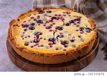 Blueberry and red currant pie on wooden board with checkered cloth Blueberry and red currant pie on wooden board with checkered cloth 141155670