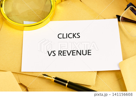 A card showing clicks versus revenue is surrounded by envelopes, glasses, and a pen on a desk. This scene reflects the focus on marketing metrics and analysis A card showing clicks versus revenue is surrounded by envelopes, glasses, and a pen on a desk. This scene reflects the focus on marketing metrics and analysis 141156608