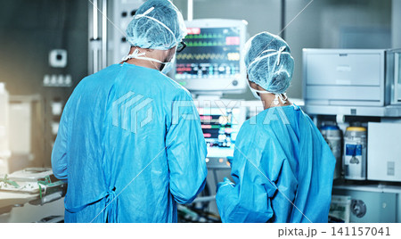 Surgery, back or surgeons with teamwork for emergency, accident or healthcare in hospital clinic. Heart rate monitor, medical or doctors in surgical collaboration in operating room to support or help Surgery, back or surgeons with teamwork for emergency, accident or healthcare in hospital clinic. Heart rate monitor, medical or doctors in surgical collaboration in operating room to support or help 141157041