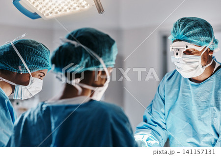 Doctor, surgery and operating room with face mask for medical emergency, operation or hospital. People, teamwork and healthcare for accident wellness for healing procedure, collaboration or helping Doctor, surgery and operating room with face mask for medical emergency, operation or hospital. People, teamwork and healthcare for accident wellness for healing procedure, collaboration or helping 141157131