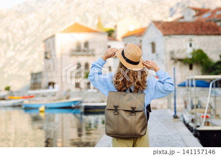 A woman tourist walks and enjoys the views and attractions. Travelling, lifestyle, adventure. A woman tourist walks and enjoys the views and attractions. Travelling, lifestyle, adventure. 141157146