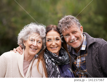Portrait, outdoor and old parents with daughter, embrace and happiness with nature and bonding together. Face, family or adult with fresh air and hug with smile and senior mother with mature father Portrait, outdoor and old parents with daughter, embrace and happiness with nature and bonding together. Face, family or adult with fresh air and hug with smile and senior mother with mature father 141157367
