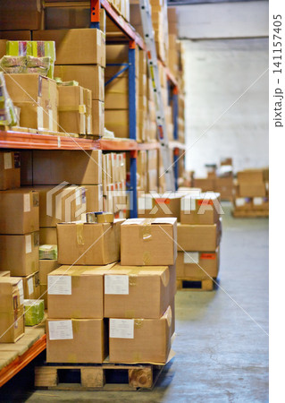 Boxes, packages and shelves with inventory at warehouse for distribution, supply chain or logistics. Empty room or interior of parcel, cargo or shipment in factory or storage for export or import 141157405