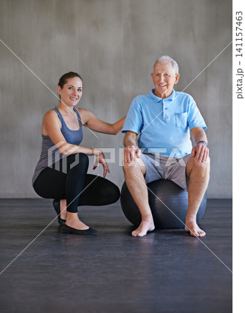 Exercise ball, smile and physiotherapist with patient for muscle exercise consultation at clinic. Physical therapy, happy and portrait of healthcare worker helping senior man at rehabilitation center Exercise ball, smile and physiotherapist with patient for muscle exercise consultation at clinic. Physical therapy, happy and portrait of healthcare worker helping senior man at rehabilitation center 141157463