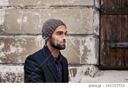 Fashion, wall or man in city thinking of casual clothes, style or edgy coat for winter outdoor outfit. Travel, cool model or stylish person walking in urban street in beanie or trendy jacket in Italy 141157723