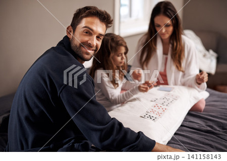 Parents, girl and playing cards for portrait in home with bonding, learning or happy for strategy in bedroom. Dad, mother and daughter with deal, deck and child on bed with connection in family house Parents, girl and playing cards for portrait in home with bonding, learning or happy for strategy in bedroom. Dad, mother and daughter with deal, deck and child on bed with connection in family house 141158143