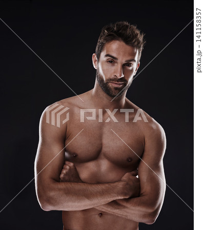 Portrait, muscle and body of confident man in studio isolated on a black background for wellness, sexy or six pack. Model, face and topless person with arms crossed for health and strong abs in Spain 141158357