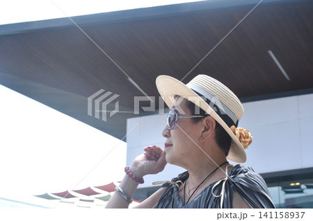 elder woman strong and healthy wearing hat in community mall garden elder woman strong and healthy wearing hat in community mall garden 141158937