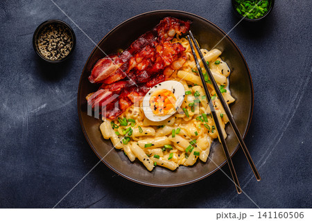 Korean street food - creamy rapokki served with bacon and egg. Korean street food - creamy rapokki served with bacon and egg. 141160506
