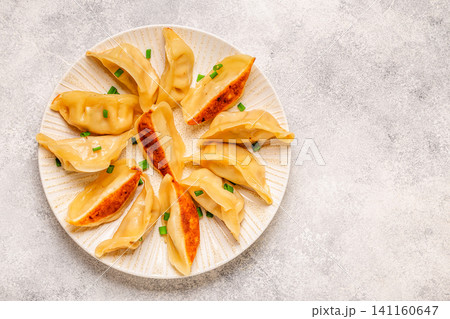 Dumplings served on a plate with green onions Dumplings served on a plate with green onions 141160647