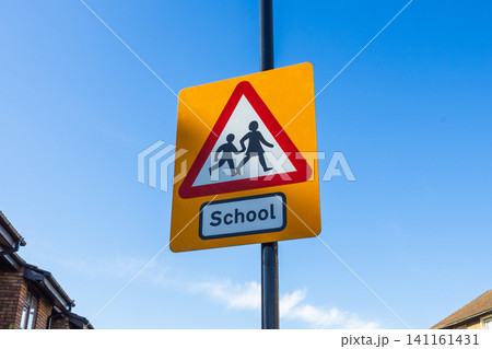 School warning road sign against a blue sky School warning road sign against a blue sky 141161431