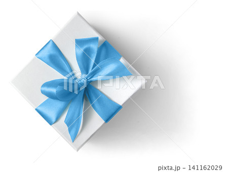 White gift box with blue ribbon and bow on a white background top view White gift box with blue ribbon and bow on a white background top view 141162029