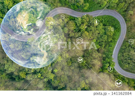 Green logistics, sustainable transportation, and net zero carbon emission to save environment. Winding road in green forest. Electric car driving. Eco-friendly road trip. Earth image provided by Nasa. 141162084