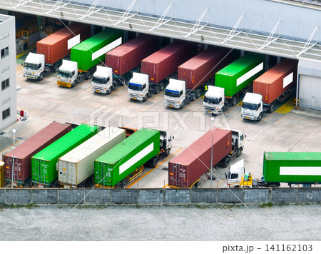 Freight trucks at warehouse loading dock. Industry logistics and distribution center. Logistics delivery and transportation. Supply chain. Shipping and cargo management. Industrial logistics hub. Freight trucks at warehouse loading dock. Industry logistics and distribution center. Logistics delivery and transportation. Supply chain. Shipping and cargo management. Industrial logistics hub. 141162103