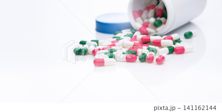 Antibiotic capsule pills spread out of plastic bottle. Pharmaceutical industry. Antibiotic drug resistance concept. Prescription drugs. Health care and medicine. Pharmacy product. Antimicrobial drugs. Antibiotic capsule pills spread out of plastic bottle. Pharmaceutical industry. Antibiotic drug resistance concept. Prescription drugs. Health care and medicine. Pharmacy product. Antimicrobial drugs. 141162144