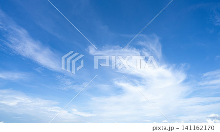 Blue sky and white cirrocumulus clouds texture background. Blue sky on sunny day. Summer sky. Cloud formation. Fluffy clouds. Nice weather in summer season. Weather pattern. Atmospheric phenomenon. 141162170