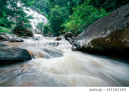 Beautiful waterfall in lush tropical green forest. Nature landscape. Mae Ya Waterfall is situated in Doi Inthanon National Park, Chiang Mai, Thailand. Waterfall flows through jungle on mountainside. Beautiful waterfall in lush tropical green forest. Nature landscape. Mae Ya Waterfall is situated in Doi Inthanon National Park, Chiang Mai, Thailand. Waterfall flows through jungle on mountainside. 141162184