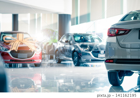 Rearview car parked in luxury showroom. Car dealership office. New car parked in modern showroom. Car for sale and rent business concept. Automobile leasing and insurance concept. Electric automobile. Rearview car parked in luxury showroom. Car dealership office. New car parked in modern showroom. Car for sale and rent business concept. Automobile leasing and insurance concept. Electric automobile. 141162195