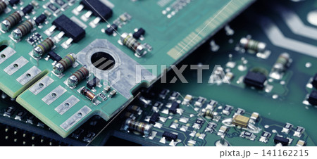 Close-up of a printed circuit board or PCB featuring wiring and microchip components. Advanced technology, precision engineering, and electronic hardware for modern devices and systems. PCB design. 141162215