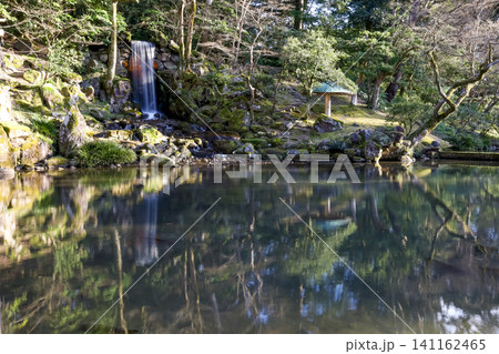 Serene Waterfall in Japanese Garden with Reflection Pond Serene Waterfall in Japanese Garden with Reflection Pond 141162465