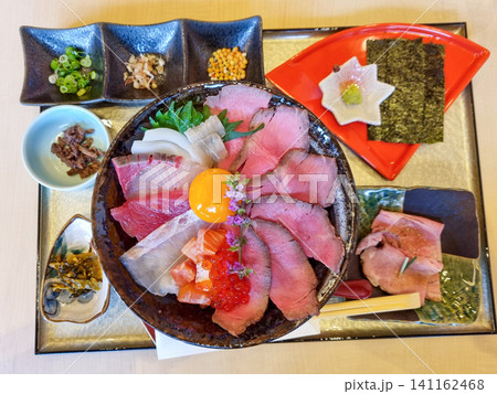 Japanese Roast Beef and fish Sashimi Bowl with Egg Yolk and Side Dishes is luxury food set Japanese Roast Beef and fish Sashimi Bowl with Egg Yolk and Side Dishes is luxury food set 141162468