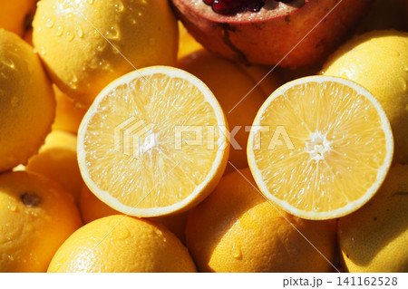 Fresh yellow lemons and pomegranate on a market stall 141162528
