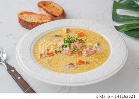 Finnish creamy salmon soup lohikeitto with vegetables served in elegant white plate Finnish creamy salmon soup lohikeitto with vegetables served in elegant white plate 141162621