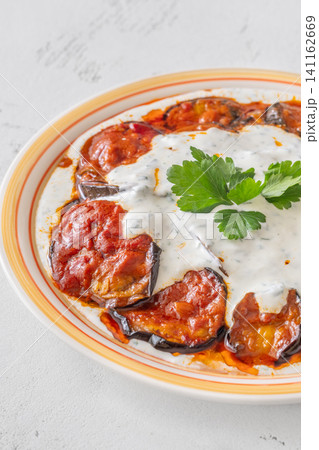 Burani Bonjan Afghan eggplant dish with yogurt garlic sauce and parsley garnish Burani Bonjan Afghan eggplant dish with yogurt garlic sauce and parsley garnish 141162669
