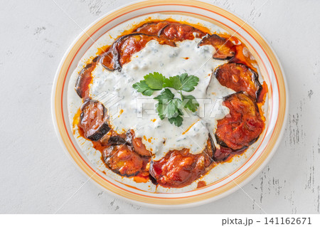 Burani Bonjan Afghan eggplant dish with yogurt garlic sauce and parsley garnish Burani Bonjan Afghan eggplant dish with yogurt garlic sauce and parsley garnish 141162671