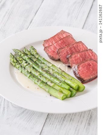 Juicy Medium Rare Steak Served With Asparagus And Lemon Butter Sauce Elegantly Juicy Medium Rare Steak Served With Asparagus And Lemon Butter Sauce Elegantly 141162687