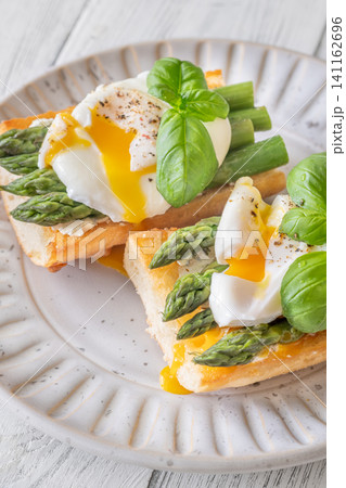 Gourmet Ciabatta Bruschetta With Runny Poached Eggs And Fresh Asparagus Beautifully Presented 141162696