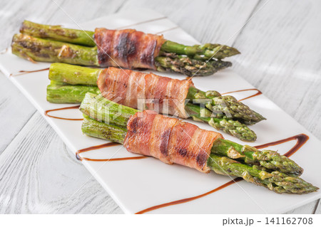Gourmet Bacon Wrapped Asparagus With Balsamic Glaze On White Ceramic Plate Gourmet Bacon Wrapped Asparagus With Balsamic Glaze On White Ceramic Plate 141162708