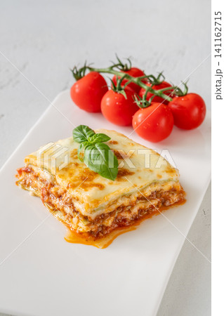Overhead Lasagna With Golden Mozzarella Basil And Fresh Cherry Tomatoes Overhead Lasagna With Golden Mozzarella Basil And Fresh Cherry Tomatoes 141162715