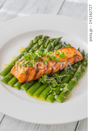Grilled Salmon Fillet With Fresh Asparagus On Elegant White Plate Grilled Salmon Fillet With Fresh Asparagus On Elegant White Plate 141162727