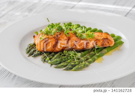 Grilled Salmon Fillet With Fresh Asparagus On Elegant White Plate Grilled Salmon Fillet With Fresh Asparagus On Elegant White Plate 141162728