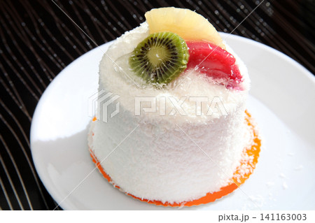 birthday cake decorated with fresh fruits 141163003