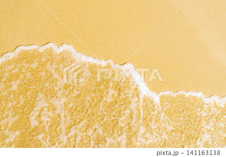 Top view of turquoise ocean waves washing onto golden sandy beach. Tropical summer background for travel, tourism, coastal branding, vacation, and relaxation. Natural background for tourism, wellness. 141163138
