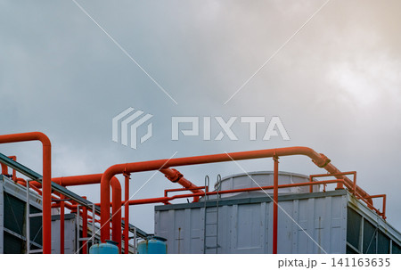 Cooling tower on roof top of building. Industrial air cooling system. Air chiller. Unit of air conditioner. Air cooled chiller with piping system on rooftop of building. Cooling tower outside building Cooling tower on roof top of building. Industrial air cooling system. Air chiller. Unit of air conditioner. Air cooled chiller with piping system on rooftop of building. Cooling tower outside building 141163635