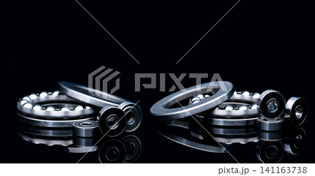 Stainless steel thrust ball bearing. Set of thrust ball bearing and shiny silver ball bearing. Spare parts for roller machine in heavy machinery and automotive industry. Round metal wheel. Stainless steel thrust ball bearing. Set of thrust ball bearing and shiny silver ball bearing. Spare parts for roller machine in heavy machinery and automotive industry. Round metal wheel. 141163738