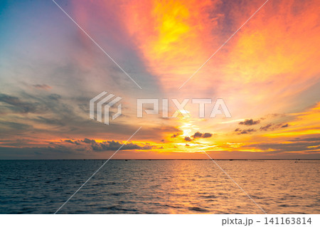 Beautiful sunset sky. Beach sunset. Twilight sea and sky. Tropical sea at dusk. Dramatic orange and blue sky. Calm sea. Sunset abstract background. Golden sky in the evening. Calm and relax life. Beautiful sunset sky. Beach sunset. Twilight sea and sky. Tropical sea at dusk. Dramatic orange and blue sky. Calm sea. Sunset abstract background. Golden sky in the evening. Calm and relax life. 141163814