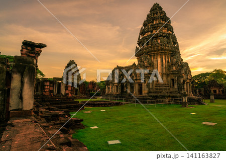Landscape of Phimai Historical Park with sunset sky. Landmark of Nakhon Ratchasima, Thailand. Travel destinations. Historic site is ancient. Ancient building. Khmer temple classical architecture. Landscape of Phimai Historical Park with sunset sky. Landmark of Nakhon Ratchasima, Thailand. Travel destinations. Historic site is ancient. Ancient building. Khmer temple classical architecture. 141163827