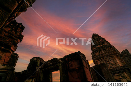 Phimai Historical Park with blue and golden sunset sky. Landmark of Nakhon Ratchasima, Thailand. Travel destinations. Historic site is ancient. Ancient building. Khmer temple classical architecture. 141163942