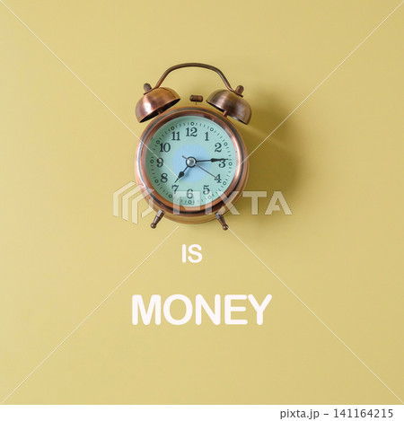 Vintage alarm clock with Time Is Money text on background. Vintage alarm clock with Time Is Money text on background. 141164215