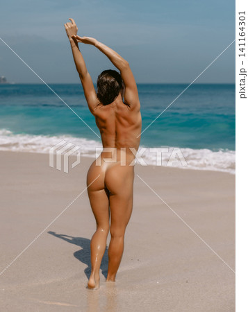 Tanned woman with perfect body relaxing on sunny beach. Tanned woman with perfect body relaxing on sunny beach. 141164301